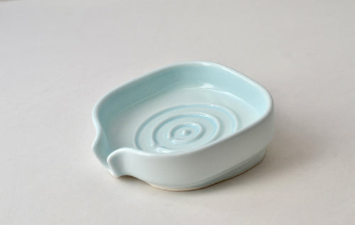 Self-Draining Porcelain Soap Dish in white with drainage holes for soap drying and storage