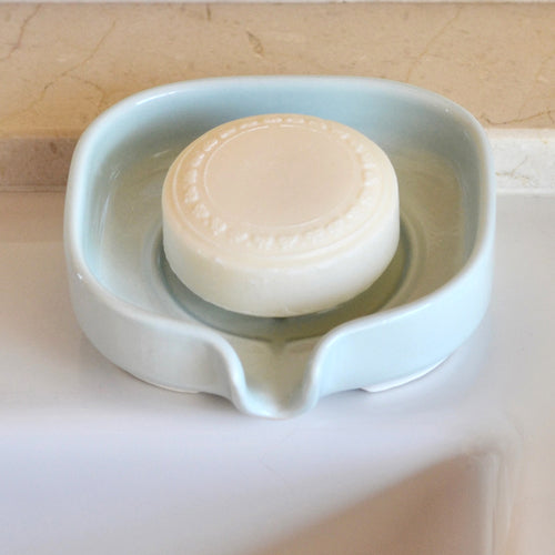 Self-Draining Porcelain Soap Dish in white with drainage holes for soap drying and storage.