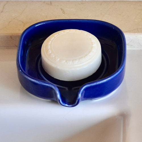 Self-Draining Porcelain Soap Dish in white with drainage holes to keep soap dry and clean.