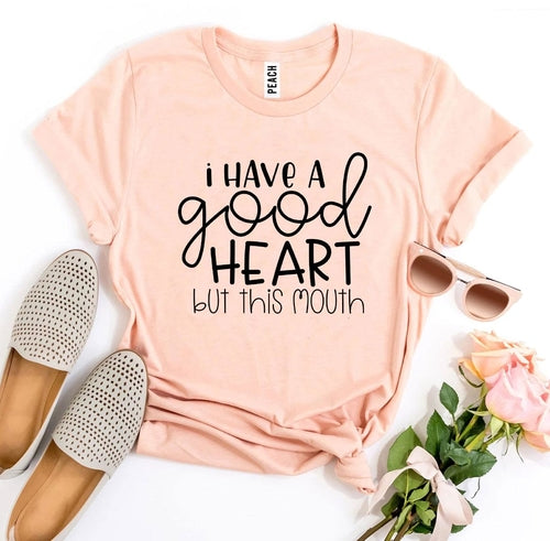 I Have a Good Heart But This Mouth T-shirt in white with black text, made of soft cotton, casual wear for men and women.