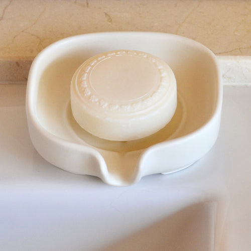 Self-Draining Porcelain Soap Dish in white with drainage holes for soap drying and storage.