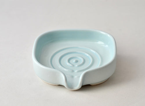 Self-Draining Porcelain Soap Dish in white with drainage holes for keeping soap dry and clean.