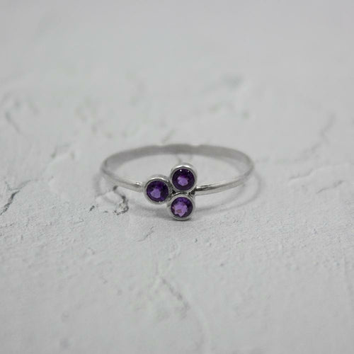 Amethyst Cluster Sterling Silver Ring with a vibrant purple gemstone set in a polished silver band.